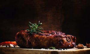 Baked pork shoulder with pepper, rosemary and garlic