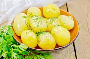 Potato boiled with parsley on the board