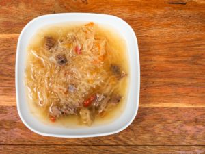 soup with stewed sour cabbage in ceramic plate
